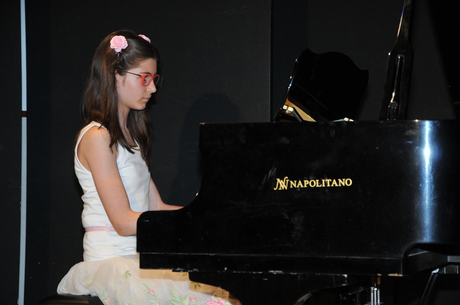 Bambina al pianoforte durante un saggio
